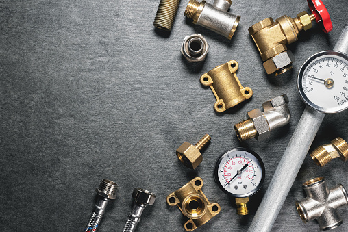 Plumbing equipment on gray flat lay background with copy space.